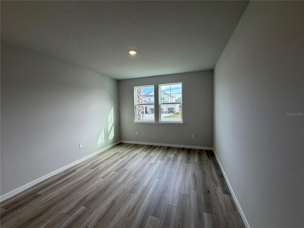 57 Pegasus Road Flagler Beach, FL 32136 - Photo 6 of 45 an empty room with wooden floor and windows