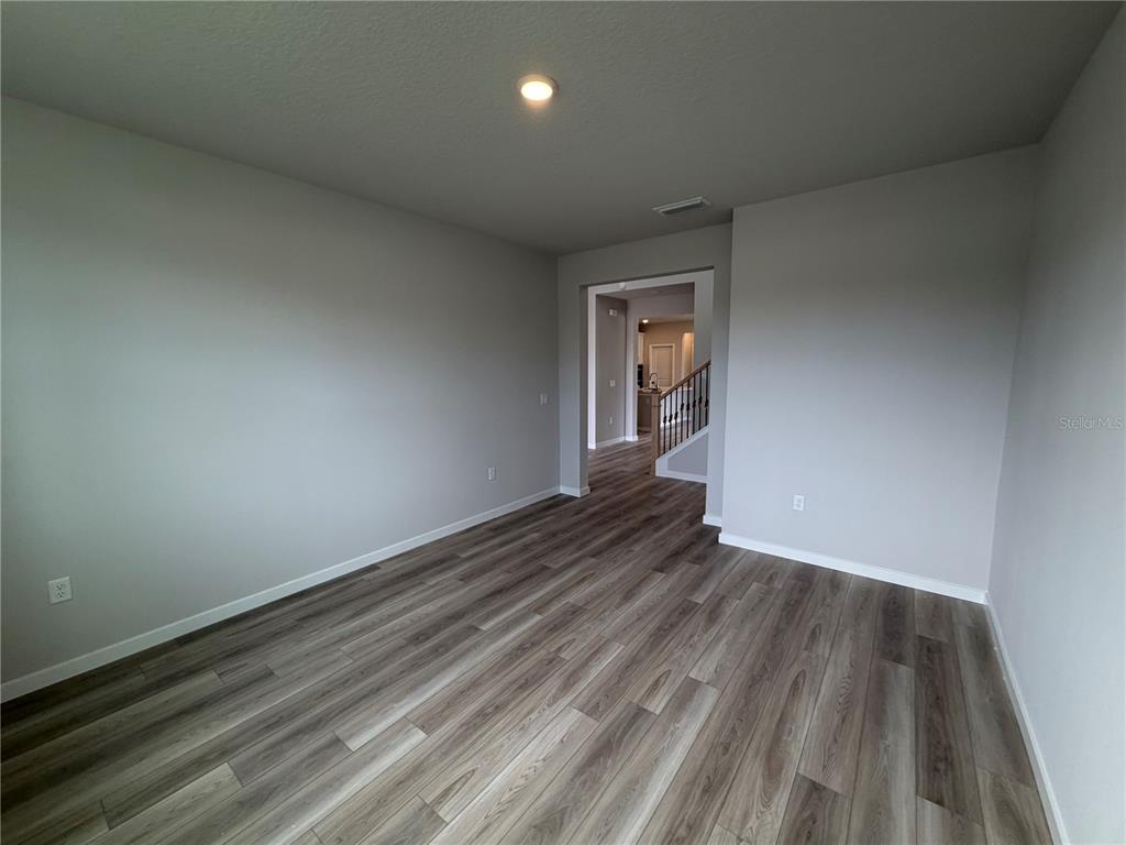 57 Pegasus Road Flagler Beach, FL 32136 - Photo 7 of 45 an empty room with wooden floor and windows