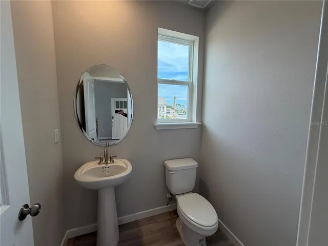 a white toilet sitting next to a bathroom sink