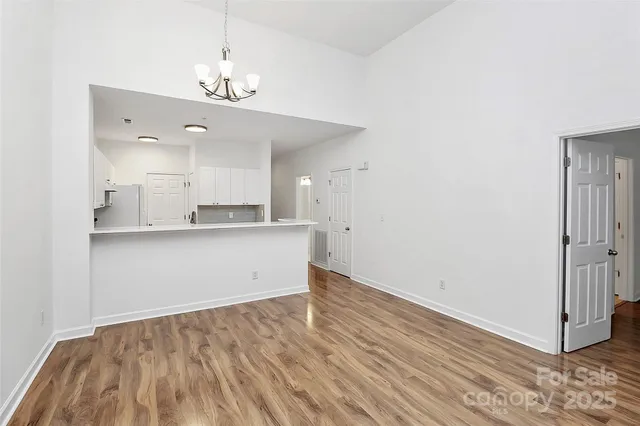 a view of kitchen with granite countertop cabinets and wooden floor