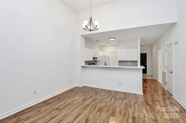 a view of a kitchen with wooden floor and a sink