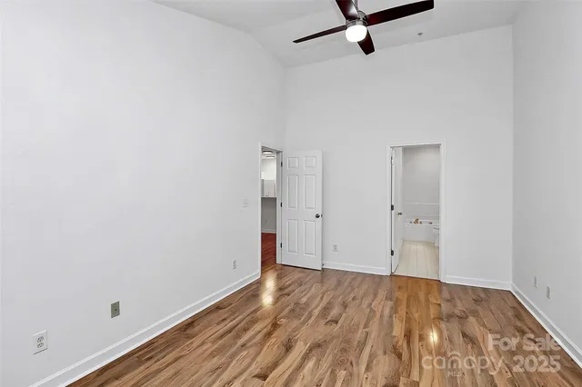 a view of a room with wooden floor and white walls