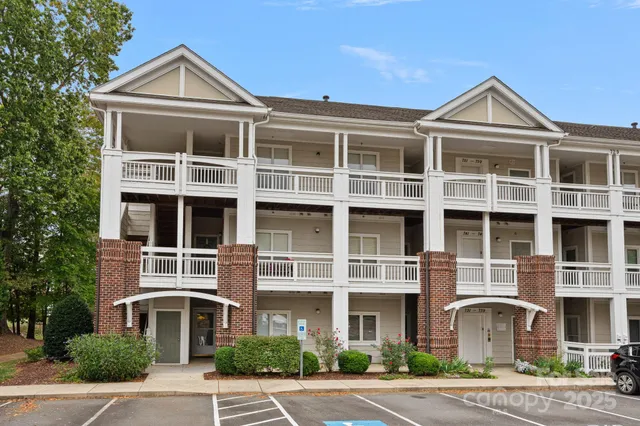 a front view of a building with a yard