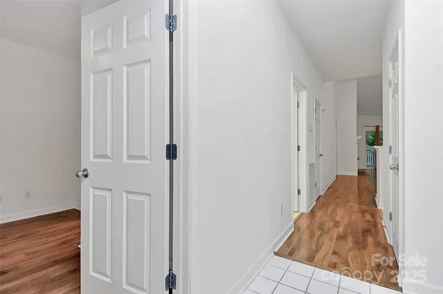 a view of a hallway with wooden floor and entryway