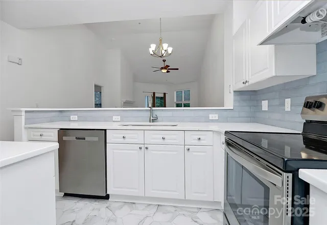a kitchen with white cabinets and a sink