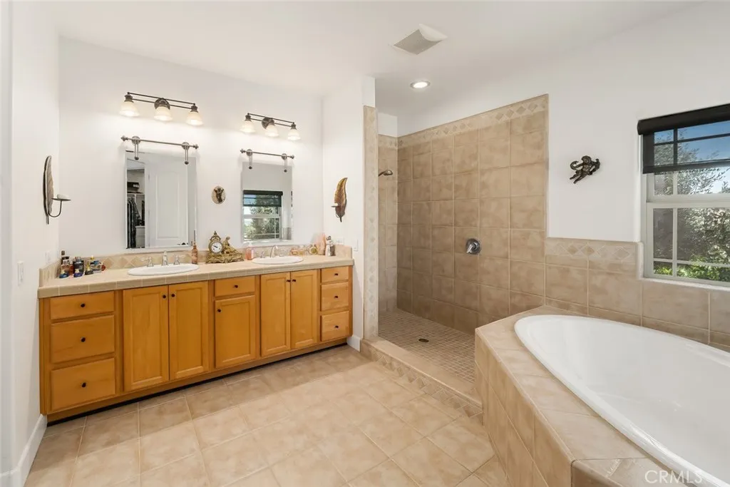 6172 Hawk Ridge Place Paso Robles, CA 93446 - Photo 34 of 72 a spacious bathroom with a tub sink double vanity and mirror