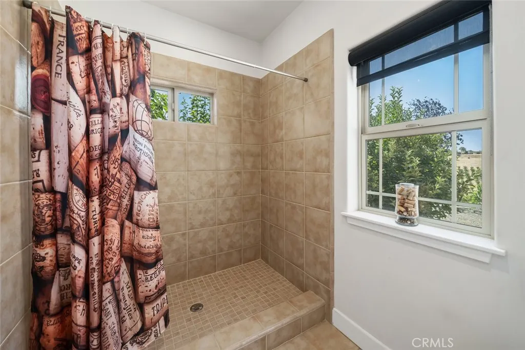 6172 Hawk Ridge Place Paso Robles, CA 93446 - Photo 51 of 72 a bathroom with a shower curtain and a window