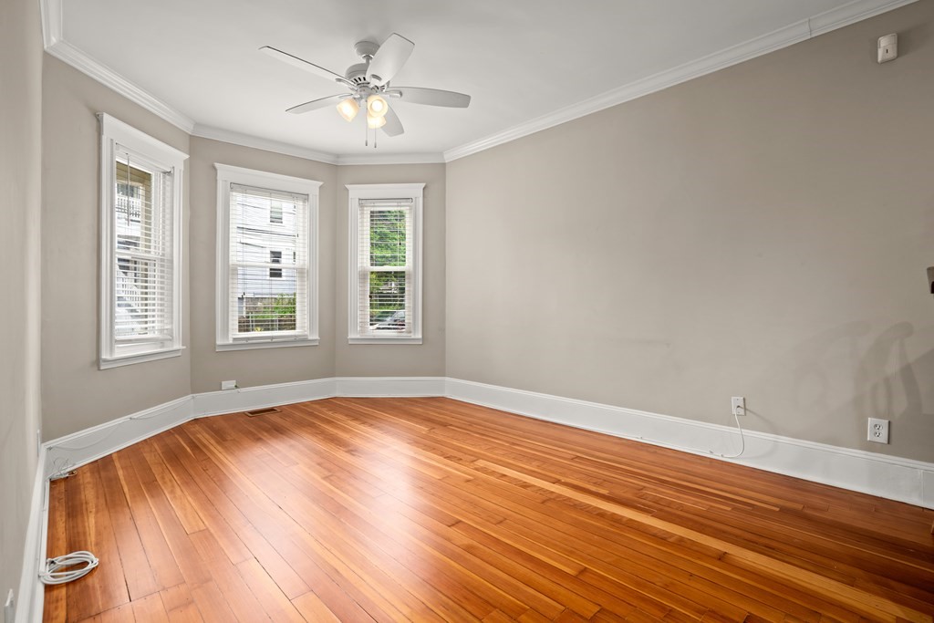 226 East Cottage Street, Unit 1 Boston, MA 02125 - Photo 2 of 12 a view of empty room with wooden floor and fan