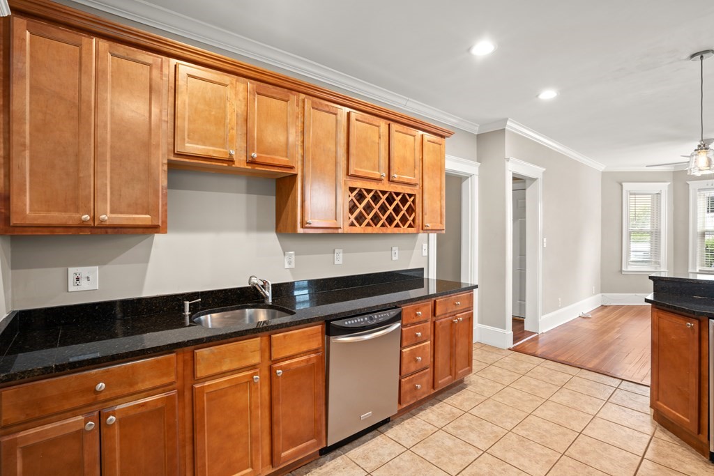 226 East Cottage Street, Unit 1 Boston, MA 02125 - Photo 6 of 12 a kitchen with granite countertop a stove a sink and a refrigerator