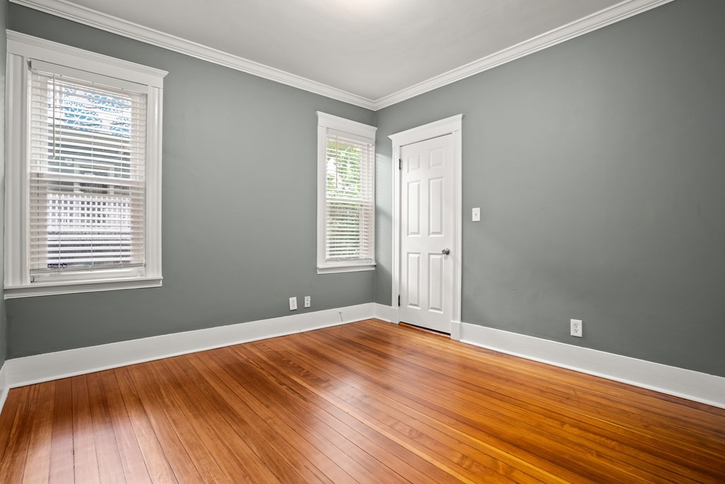 226 East Cottage Street, Unit 1 Boston, MA 02125 - Photo 9 of 12 a view of an empty room with wooden floor and a window