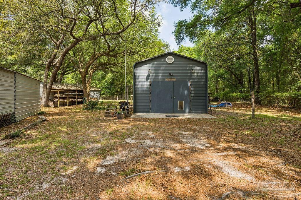 8938 Pioneer Road Holt, FL 32564 - Photo 28 of 44 a house view with a outdoor space