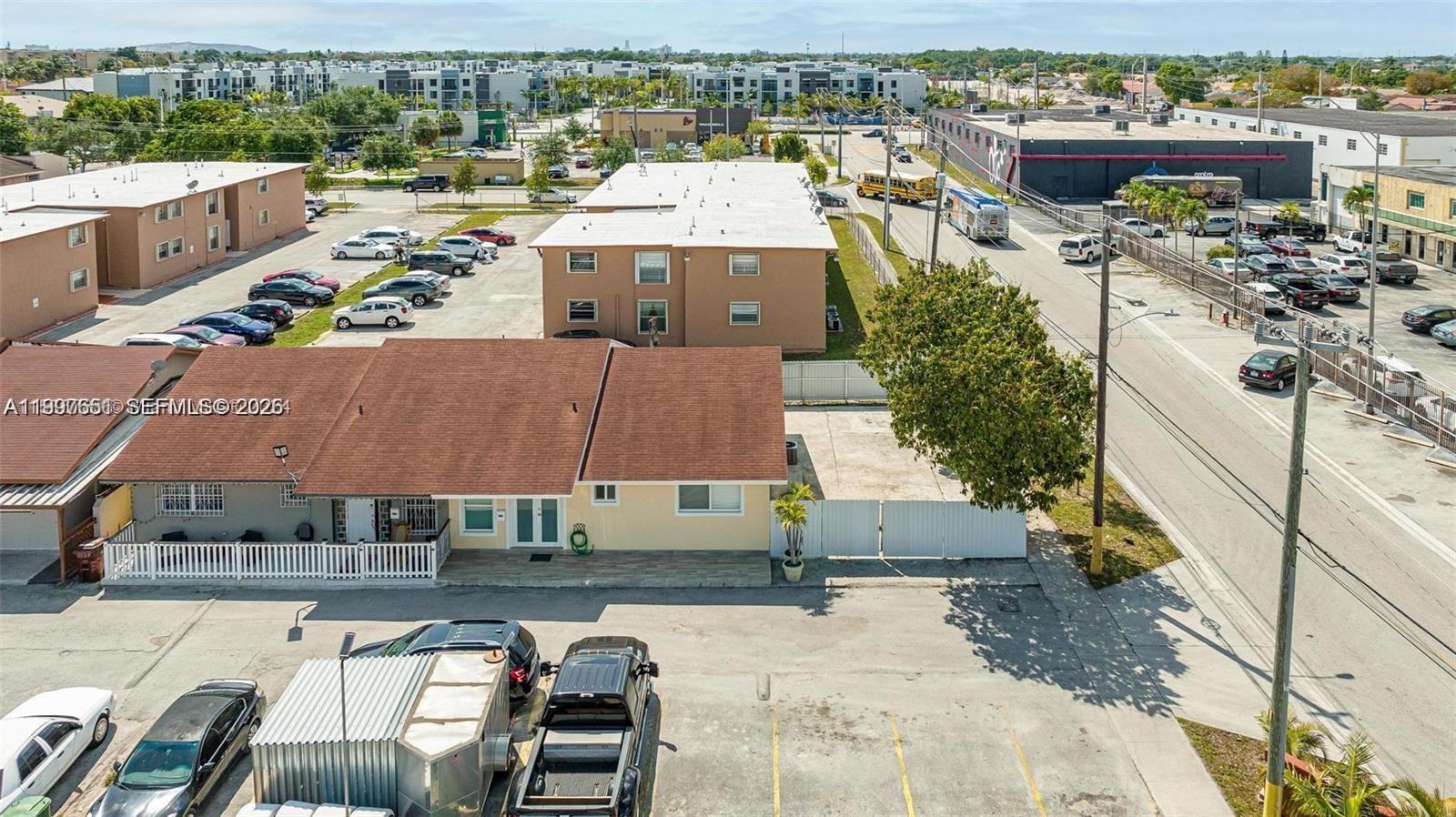 an aerial view of a house with garden space and ocean view