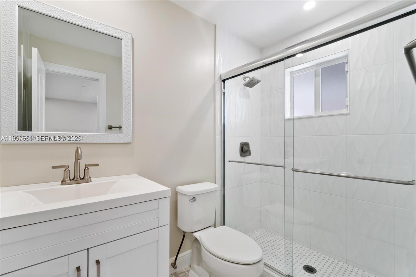 330 West 74th Place, Unit 330 Hialeah, FL 33014 - Photo 13 of 31 a bathroom with a toilet a sink and shower