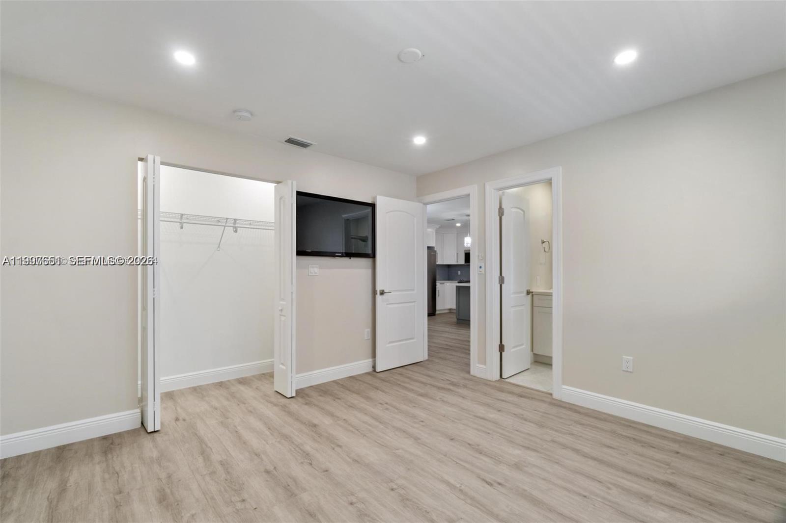330 West 74th Place, Unit 330 Hialeah, FL 33014 - Photo 14 of 31 a view of a livingroom with wooden floor