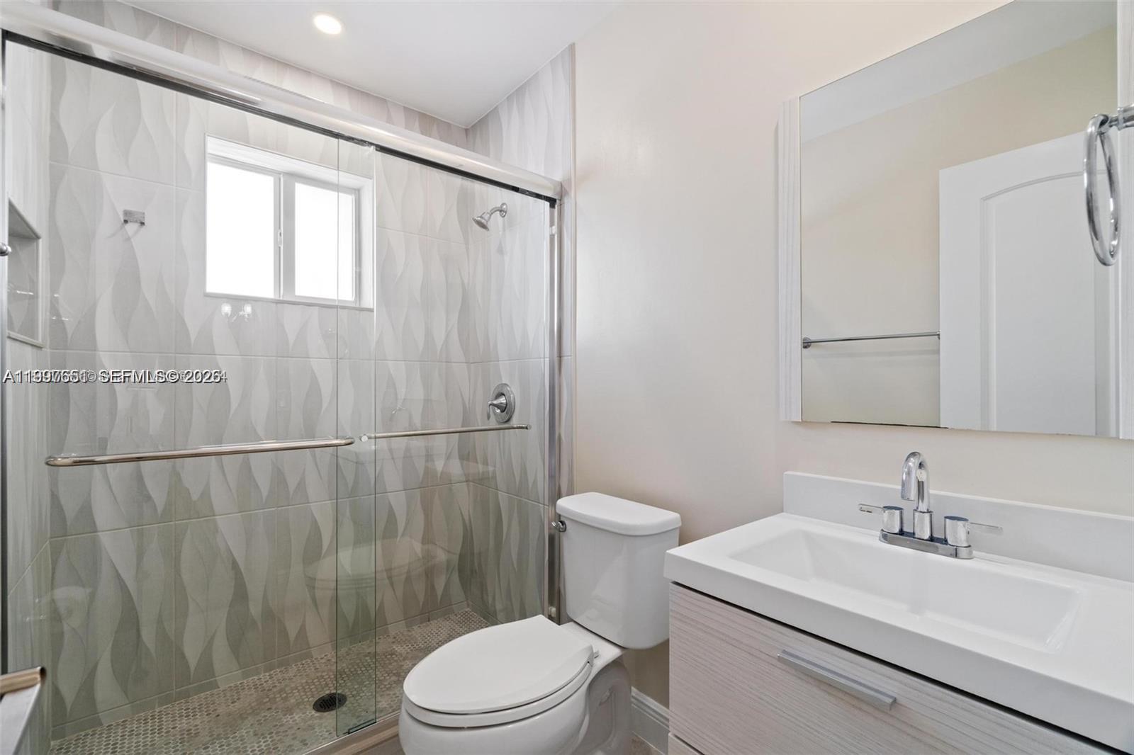 330 West 74th Place, Unit 330 Hialeah, FL 33014 - Photo 19 of 31 a bathroom with a sink a toilet and shower