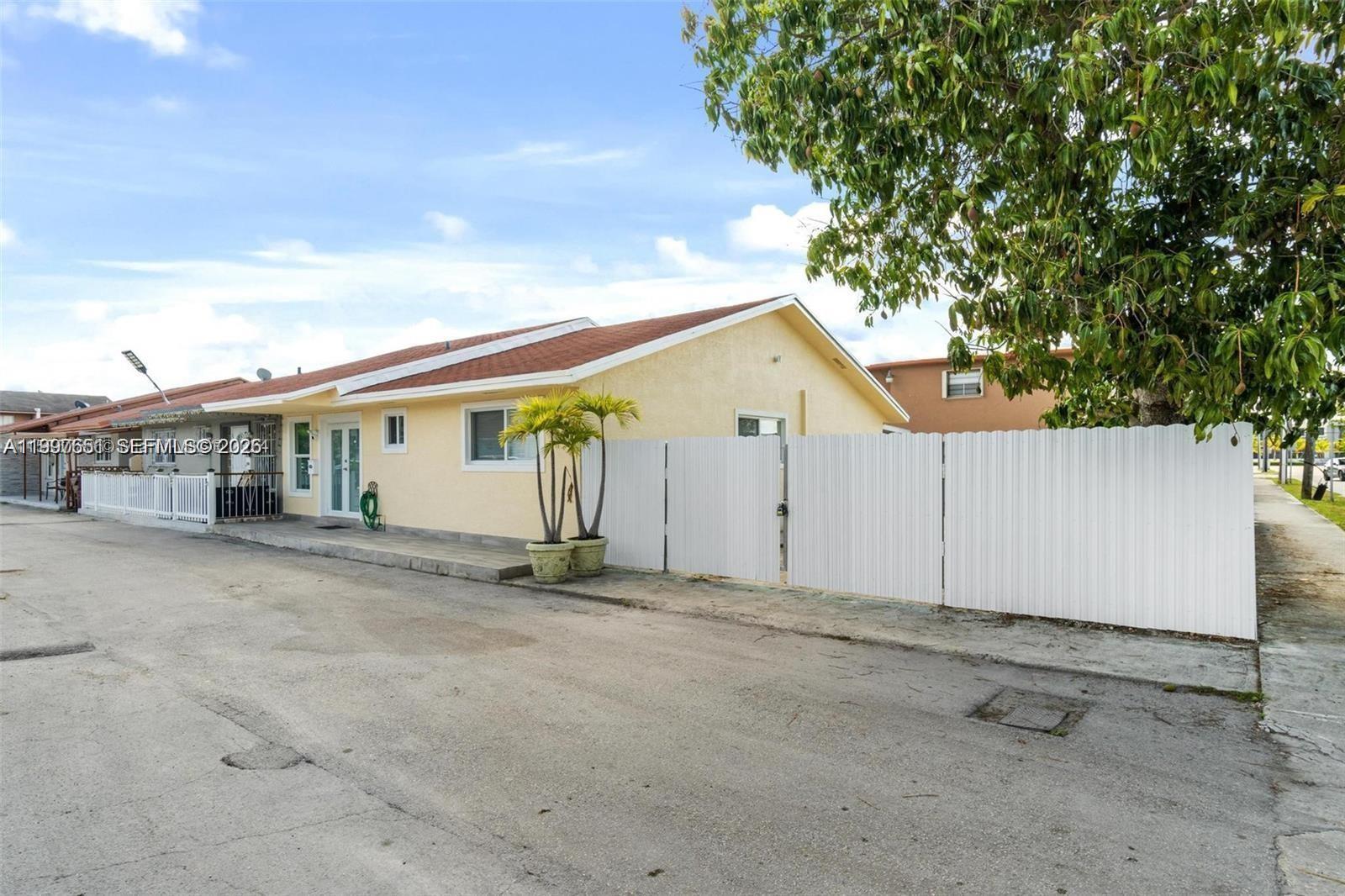 330 West 74th Place, Unit 330 Hialeah, FL 33014 - Photo 2 of 31 a view of a house with backyard and parking