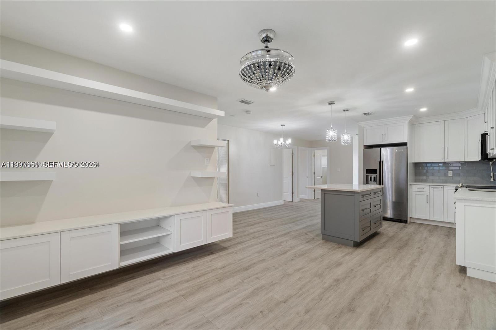 330 West 74th Place, Unit 330 Hialeah, FL 33014 - Photo 21 of 31 a view of kitchen and white cabinets with wooden floor
