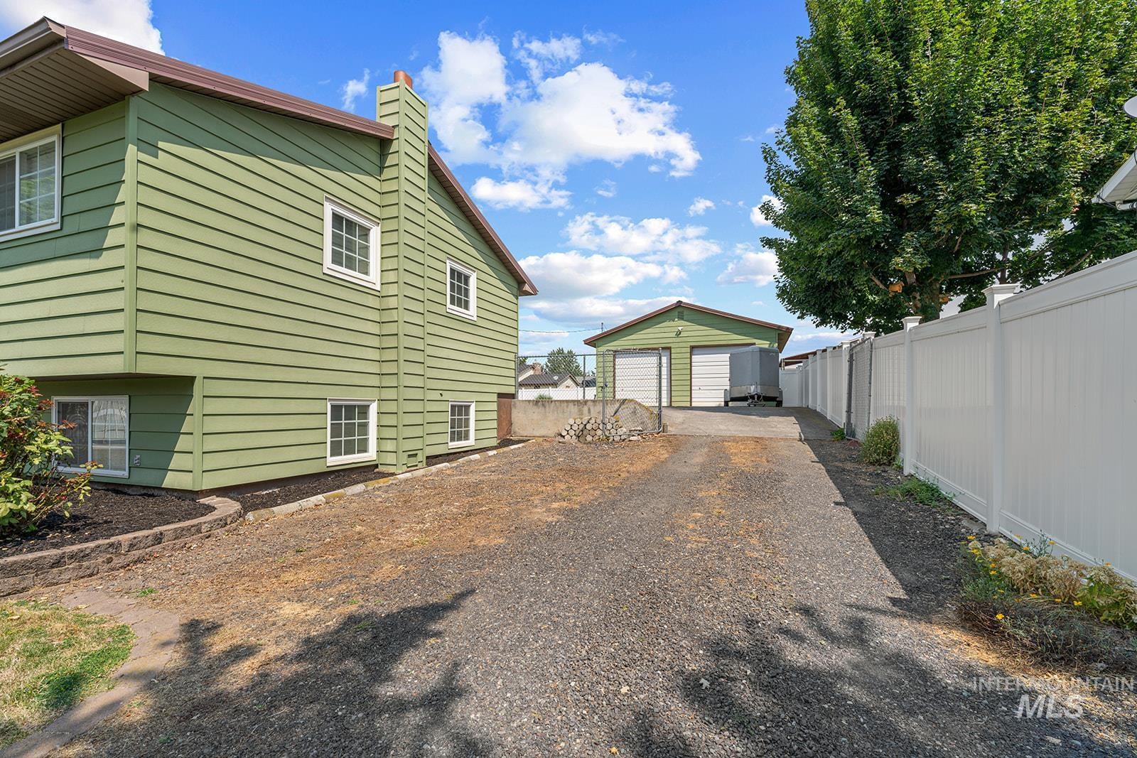 2007 Ripon Avenue Lewiston, ID 83501 - Photo 25 of 30 Side exterior featuring green siding, white-trimmed windows, and a brown roof