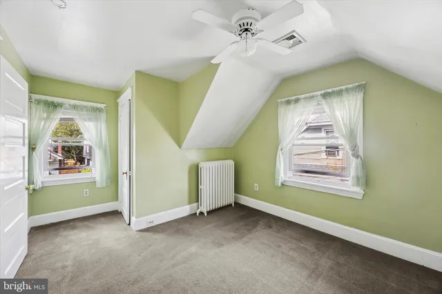 a view of a livingroom with a window and a ceiling fan