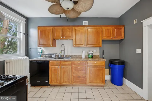 a kitchen with stainless steel appliances granite countertop a stove a sink dishwasher and a microwave oven with cabinets