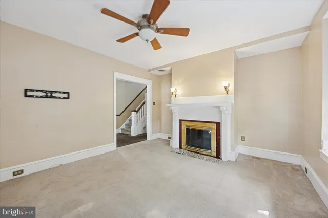 a view of empty room with fireplace