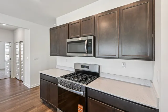 an empty room with wooden floor and garden