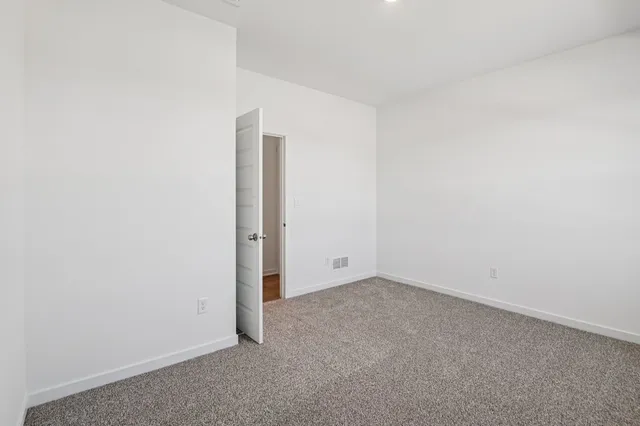 a view of walk in closet with empty racks