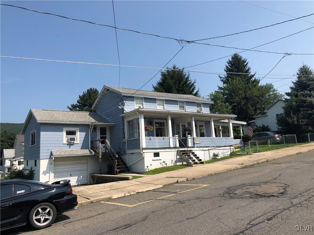 13 West Ruddle Street, Unit 15 Coaldale, PA 18218 - Photo 2 of 3 a front view of a house with a porch and a yard