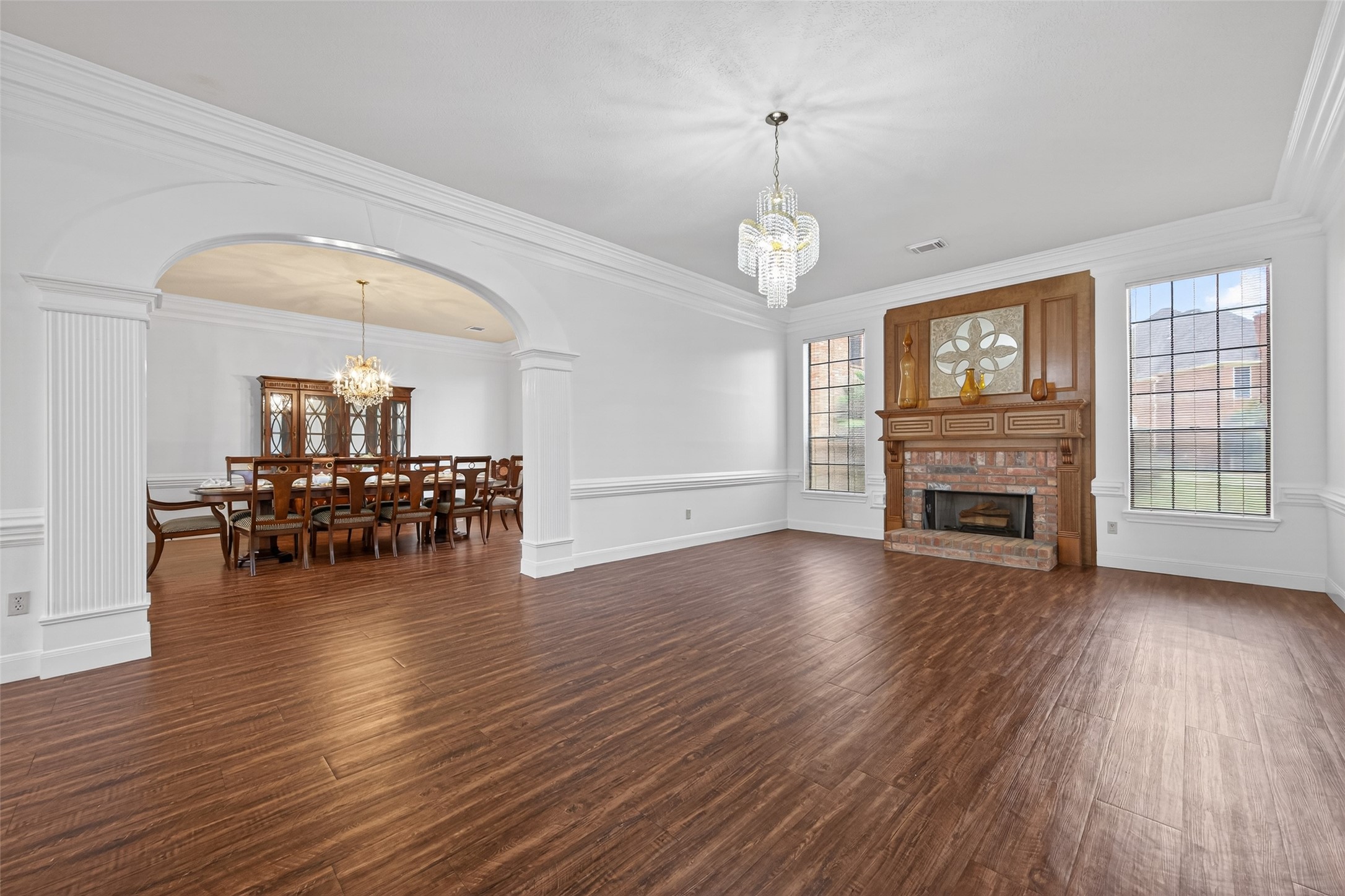 17315 Rothko Lane Spring, TX 77379 - Photo 11 of 50 Elegant formal living and dining areas featuring rich wood-like flooring, detailed crown molding, and classic architectural accents throughout.