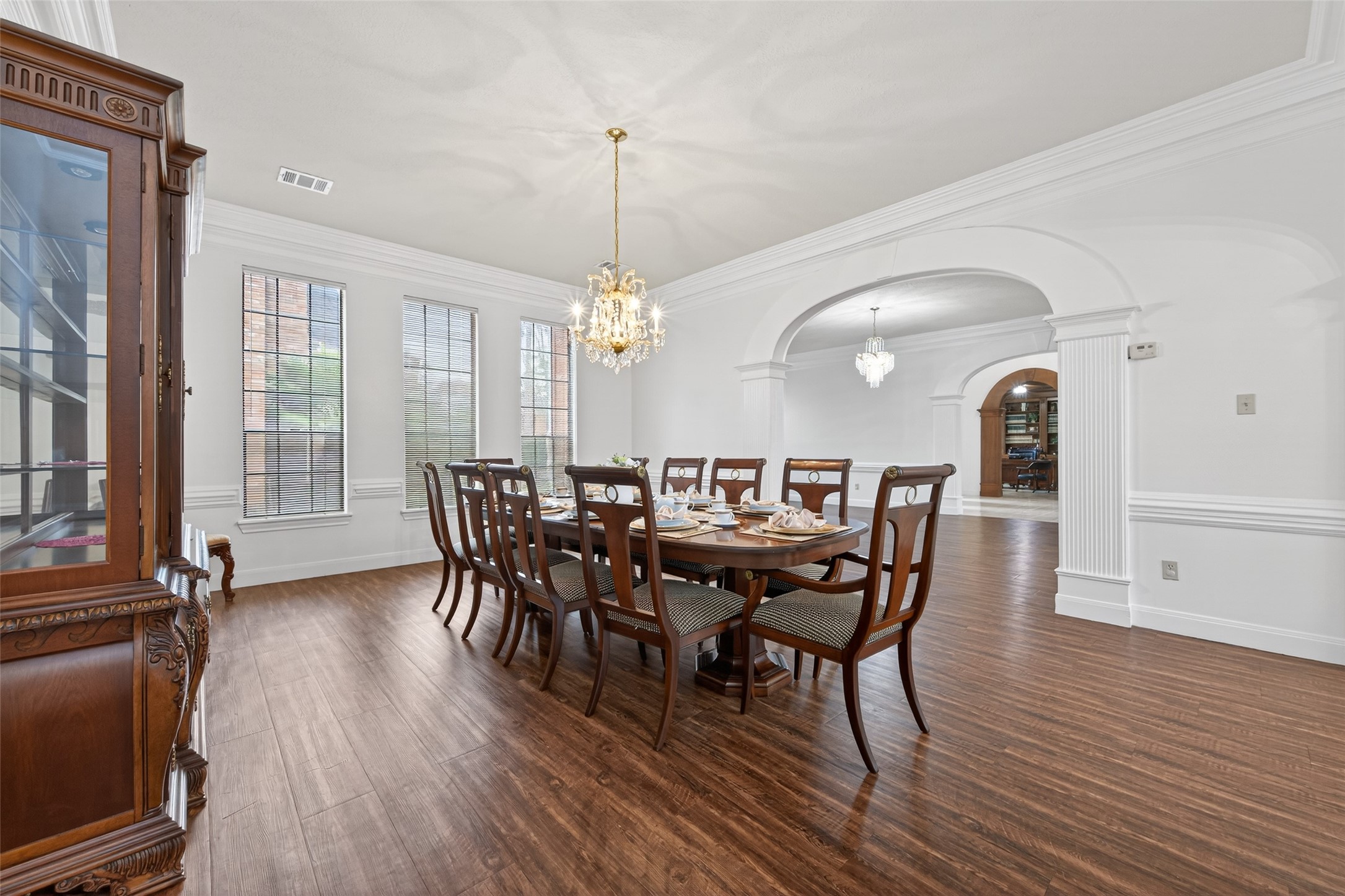 17315 Rothko Lane Spring, TX 77379 - Photo 12 of 50 This spacious area offers abundant natural light, a stunning glass chandelier, and beautiful columned archways that enhance the home's timeless architectural charm.