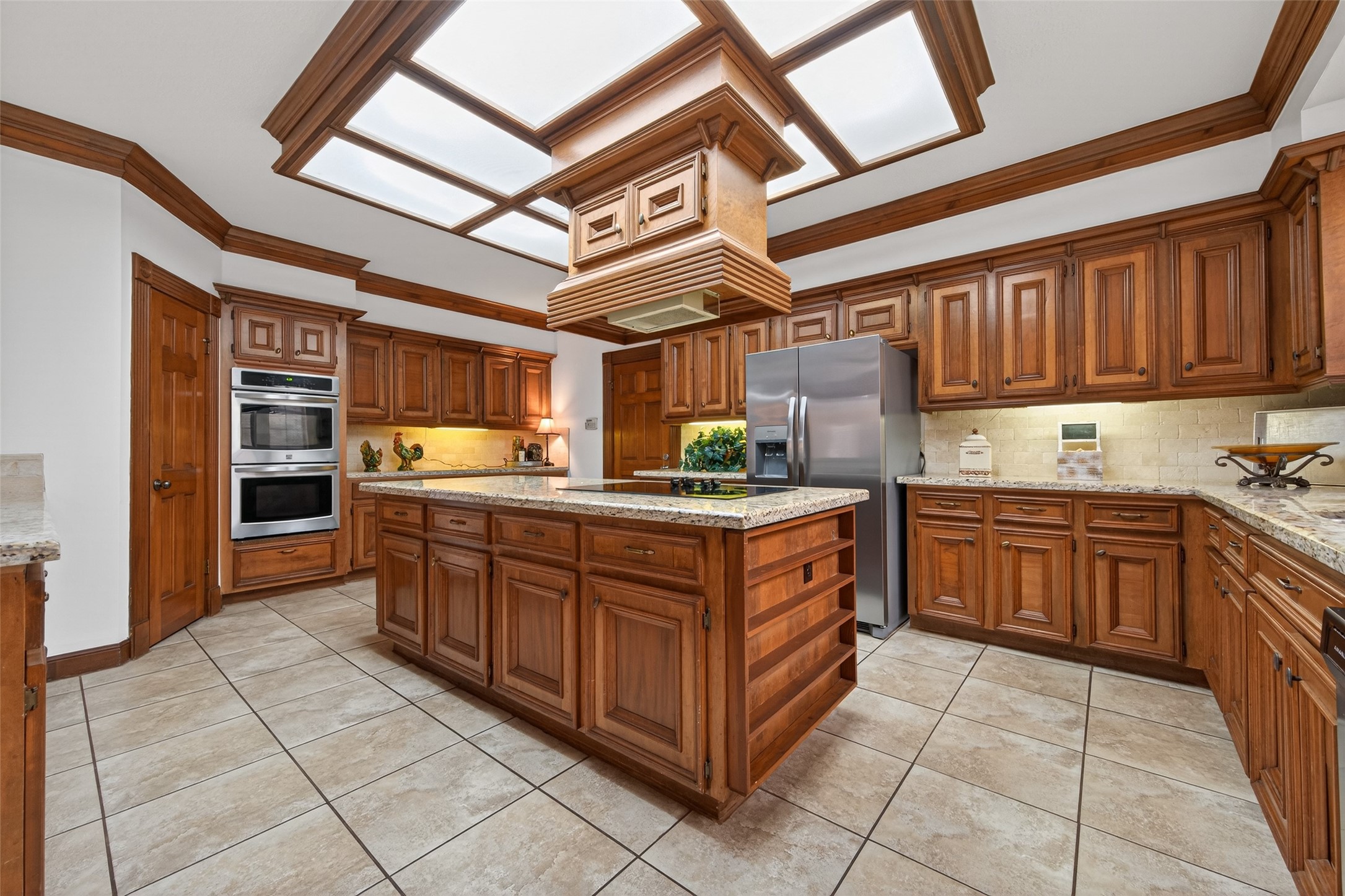 17315 Rothko Lane Spring, TX 77379 - Photo 14 of 50 This spacious kitchen offers stainless steel appliances, double ovens, ample storage, a walk-in pantry, timeless granite counter tops. Elegant ceiling details and under cabinet lighting enhance the warm, inviting atmosphere, making this space perfect for both everyday living and hosting.