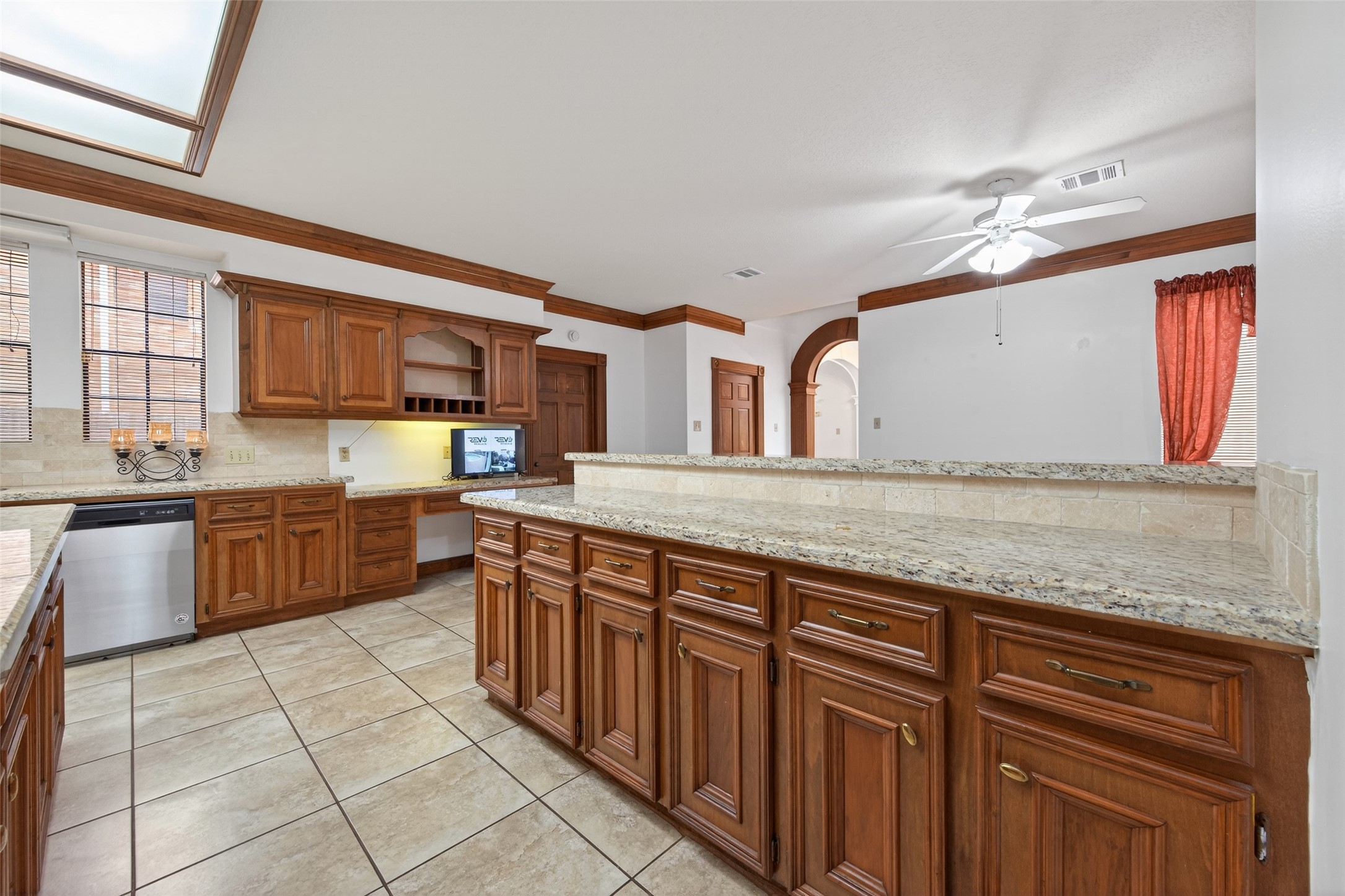 17315 Rothko Lane Spring, TX 77379 - Photo 15 of 50 Elegant gourmet kitchen with rich custom cabinetry, granite countertops, and an oversized breakfast bar. Designed for upscale living and effortless entertaining with abundant storage and a seamless open layout.