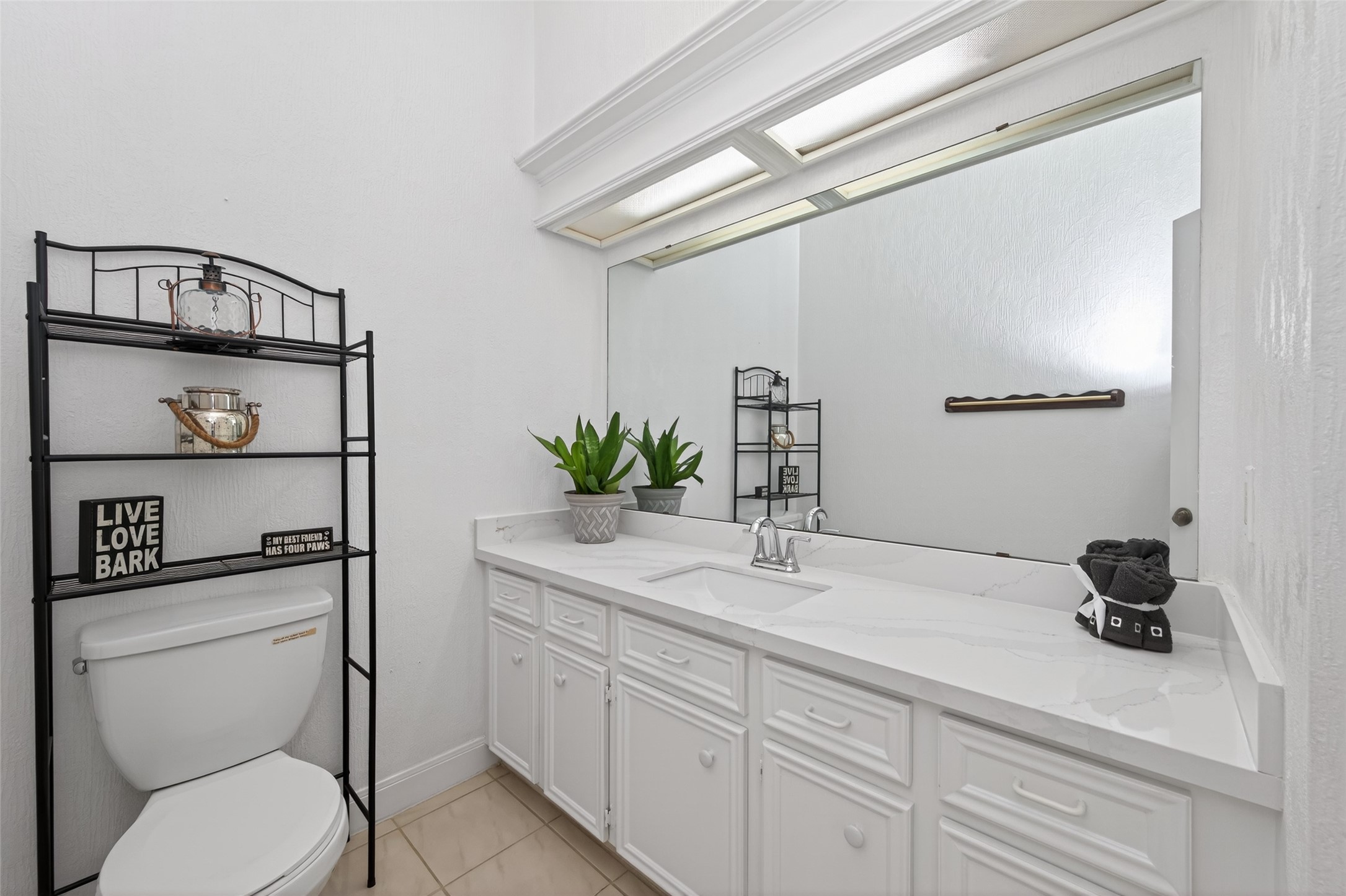 17315 Rothko Lane Spring, TX 77379 - Photo 19 of 50 This bathroom features quartz countertops, a spacious vanity, and ample cabinet space, offering a clean designed and everyday comfort.