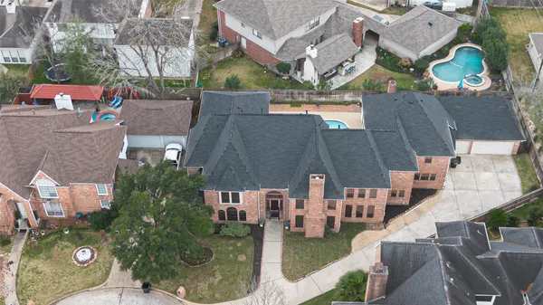 an aerial view of residential houses with outdoor space and parking