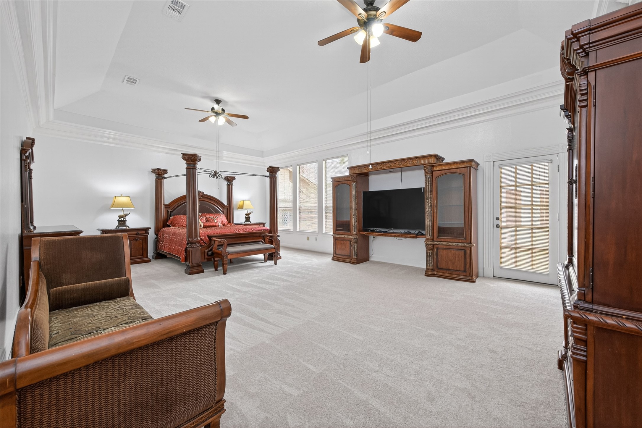 17315 Rothko Lane Spring, TX 77379 - Photo 21 of 50 Luxurious primary suite featuring an expansive layout, high ceilings, and abundant natural light. This elegant retreat offers ample space for a sitting area, large windows, and a serene atmosphere designed for comfort and relaxation.