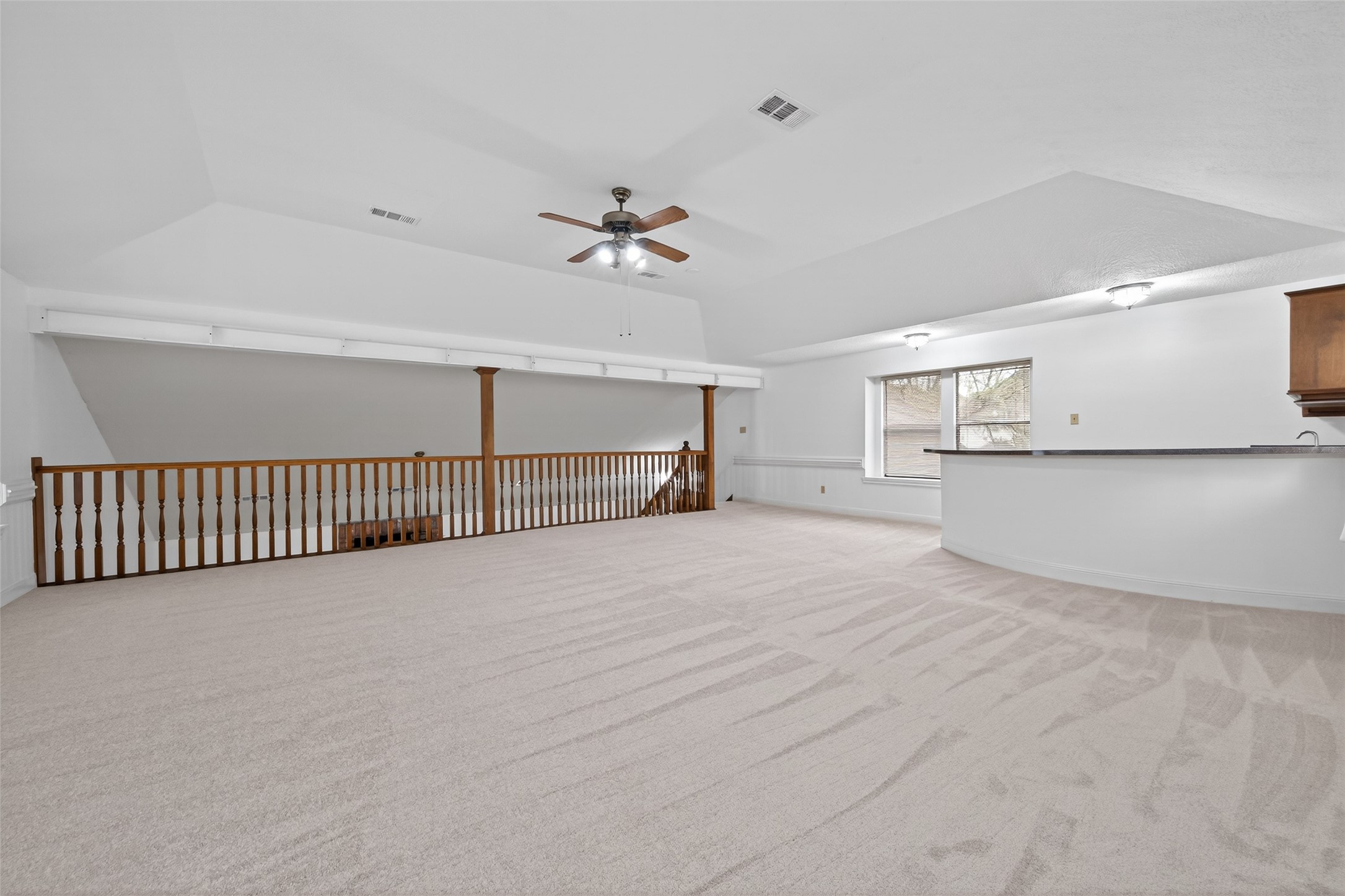 17315 Rothko Lane Spring, TX 77379 - Photo 23 of 50 this spacious game room features high ceilings, abundant natural light, and an open layout overlooking the family room area. This space is perfect for entertaining, a media space, or a private retreat, offering comfort and versatile living options.