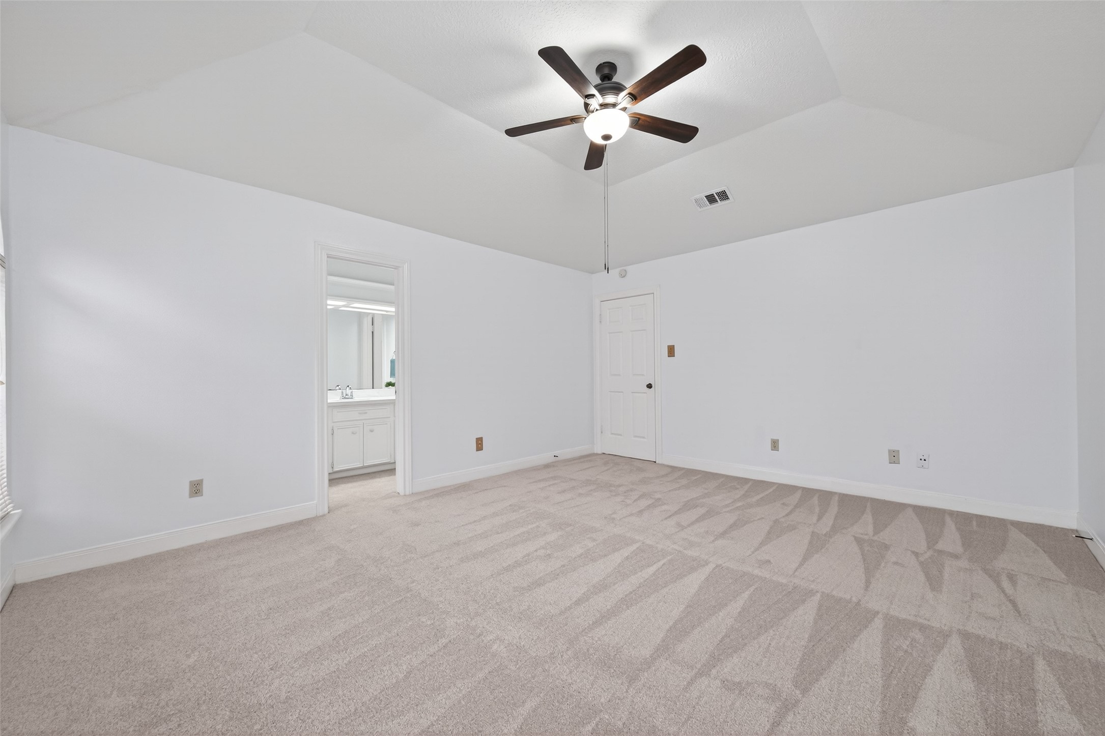 17315 Rothko Lane Spring, TX 77379 - Photo 24 of 50 Spacious bedroom featuring vaulted ceilings, new carpet, and a serene jack and jill bath. Designed for comfort and relaxation with an open, aire feel and elegant ambiance.