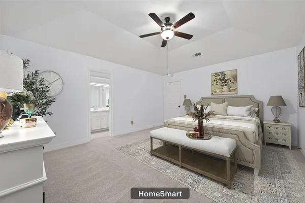 a spacious bedroom with a bed and a chandelier