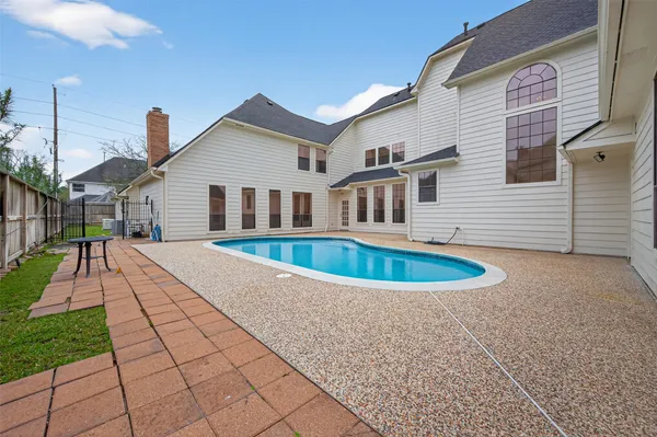 a living room with furniture and large windows