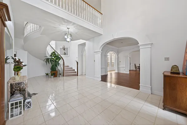 a view of a dining room with furniture a chandelier and wooden floor