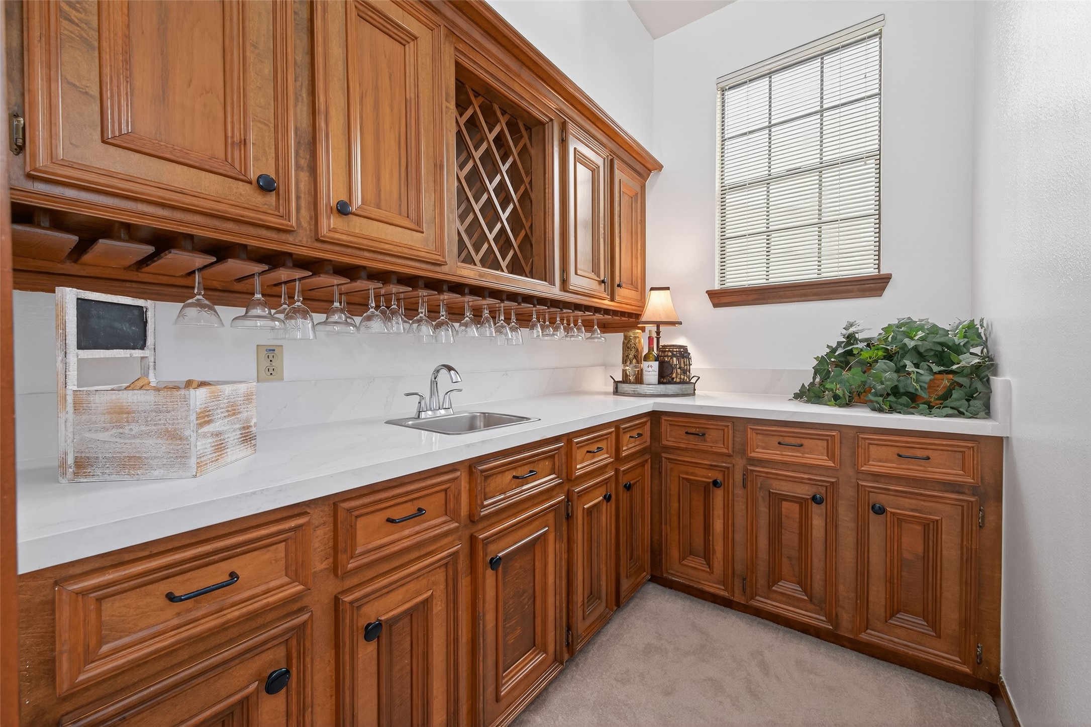 17315 Rothko Lane Spring, TX 77379 - Photo 9 of 50 This well appointed wet bar features custom wood cabinetry, abundant storage, and an elegant built-in wine rack.