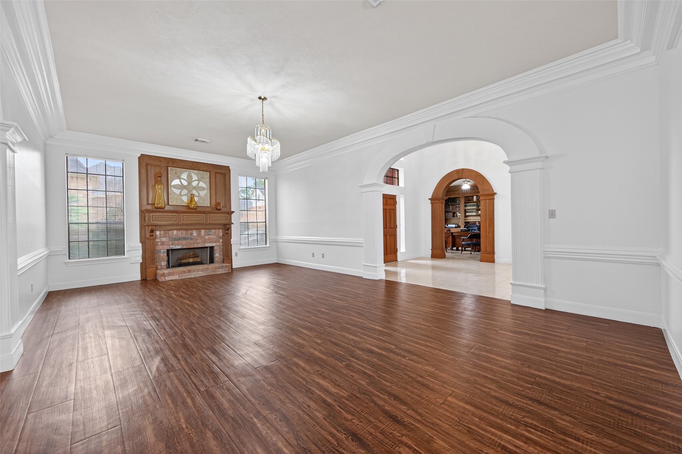 17315 Rothko Lane Spring, TX 77379 - Photo 10 of 50 This inviting space offers abundant natural light, a beautiful fireplace with a custom wood mantle, and graceful archway openings that create seamless flow between living areas.