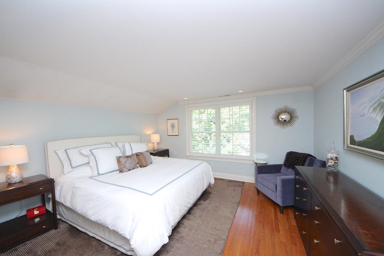 25 Ridgewood Road Norwalk, CT 06853 - Photo 11 of 37 a bedroom with a bed and a flat tv screen on the dresser