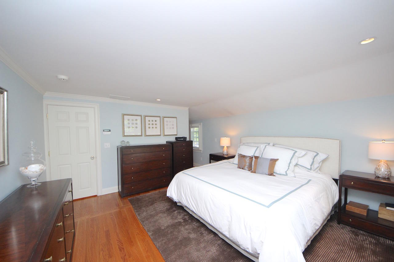 25 Ridgewood Road Norwalk, CT 06853 - Photo 12 of 37 a bedroom with a bed and wooden floor