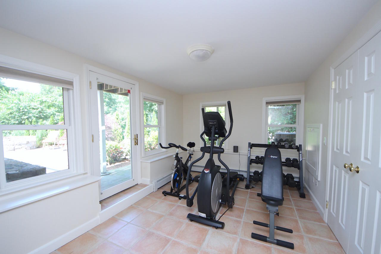 25 Ridgewood Road Norwalk, CT 06853 - Photo 20 of 37 a view of a room with gym equipment and windows