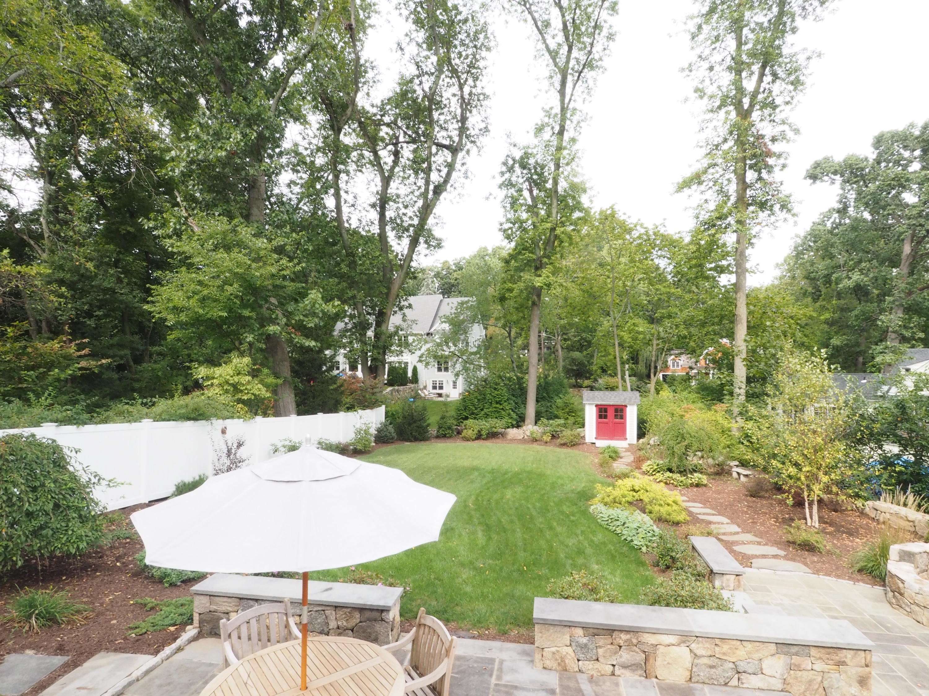 25 Ridgewood Road Norwalk, CT 06853 - Photo 26 of 37 a view of a backyard with table and chairs plants and large trees