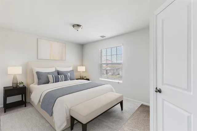 a bedroom with a bed and a window