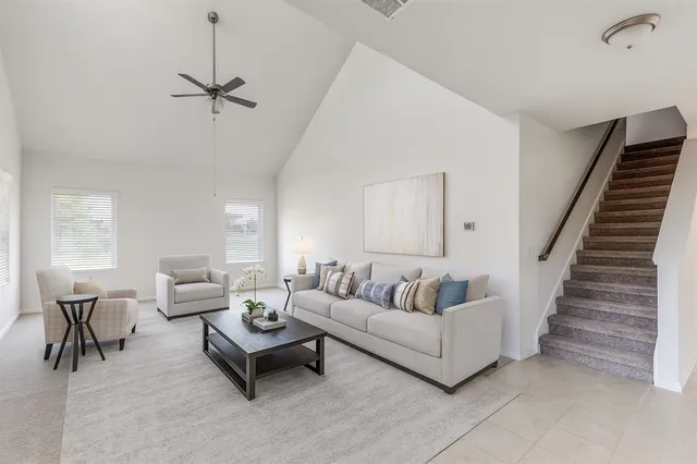 a living room with furniture and a potted plant