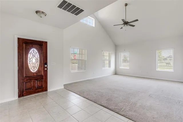 a view of an empty room and a window