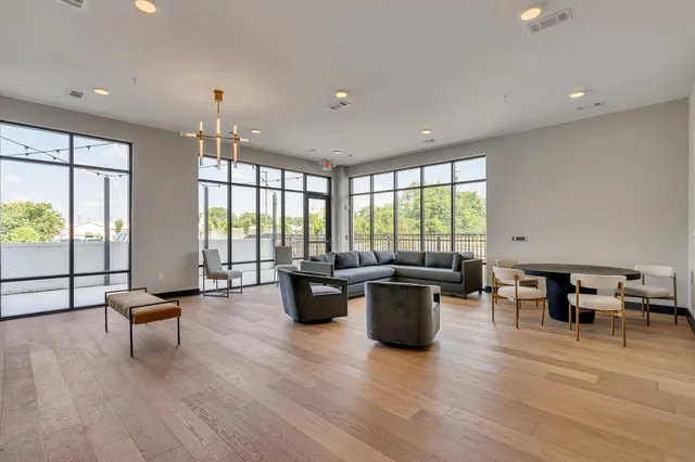 a view of a livingroom with a couch and wooden floor